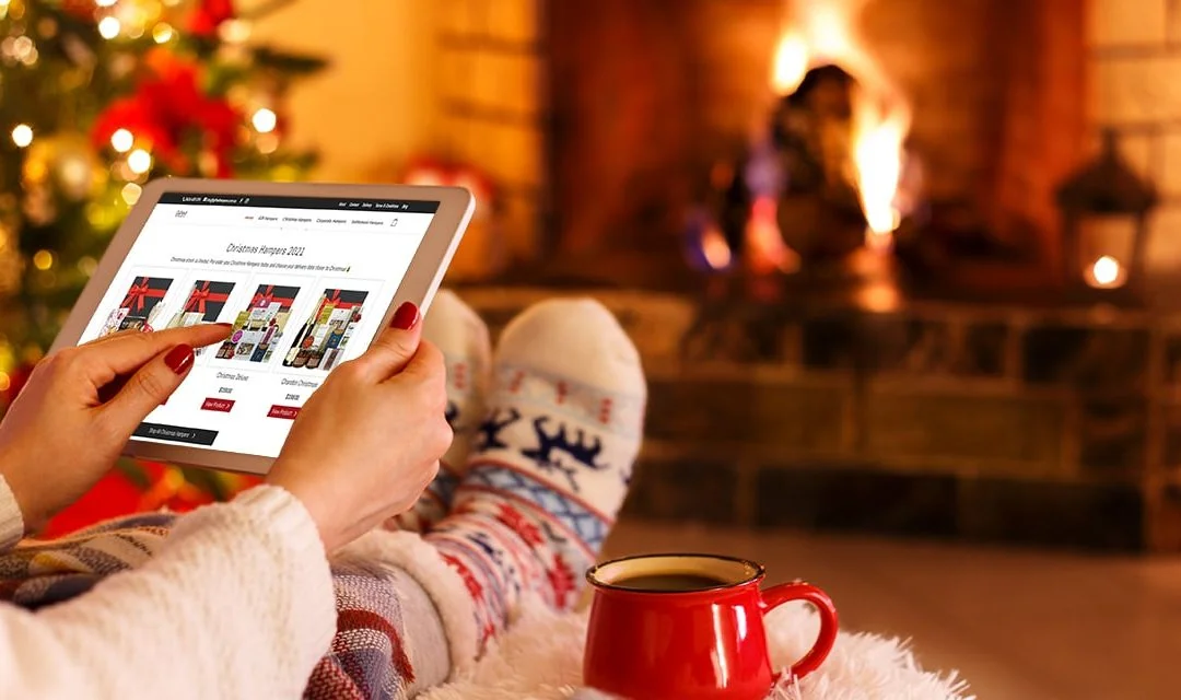Woman Orders Last-Minute Christmas Gifts by Fire Place